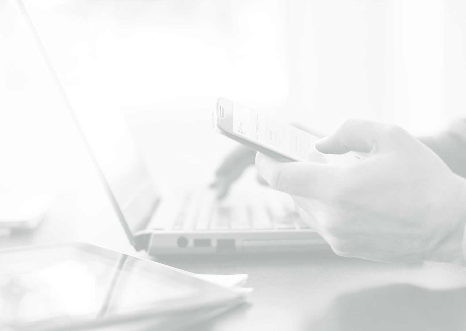 Our people banner image of staff using phone and laptop